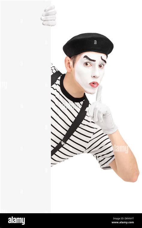 Male Mime Artist Holding A Blank Panel And Gesturing Silence With A