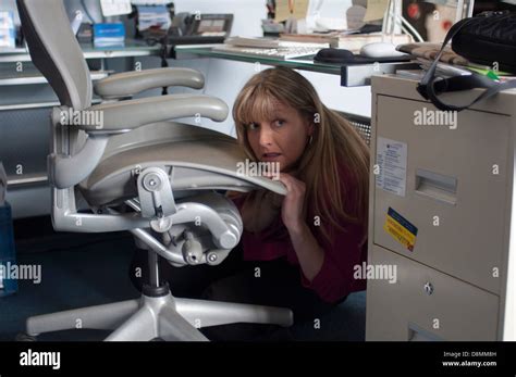 Woman Hiding Under Her Desk Stock Photo Alamy