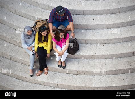 Four People Seated On The Half Circular Stairs Of Southern Entrance Of