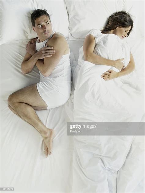 Woman Wrapped In Bed Sheets Man Shivering Photo Getty Images