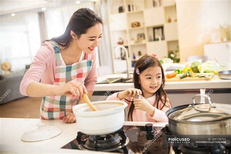 Focused 265138702 Stock Photo Happy Asian Mother Daughter Cooking 