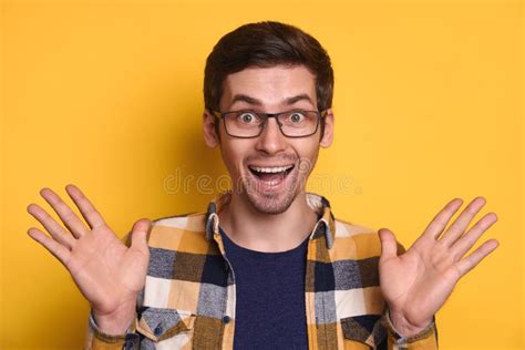 Handsome Surprised Guy Making Omg Hand Gesture Isolated Over Yellow