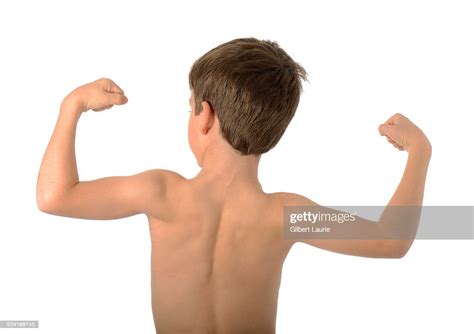 Boy Poses Flexing His Muscles High Res Stock Photo Getty Images