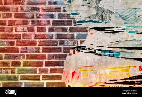 Brick With Torn Posters As Creative And Abstract Background Stock Photo