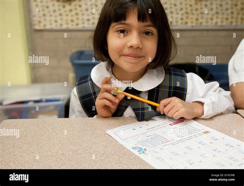 Smiling Hispanic Second Grade Elementary School Girl Wearing Uniform In