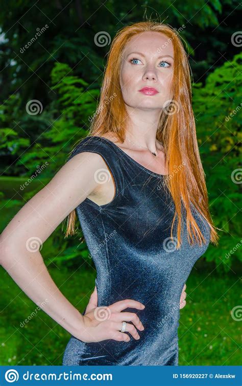 red haired girl posing at dusk in the park stock image image of green glisten 156920227