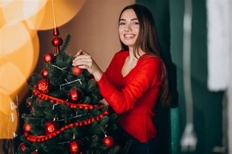 Free Photo Woman Decorating Christmas Tree On Christmas