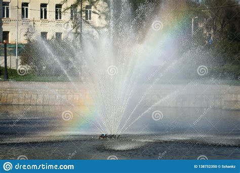 Rainbow In Splashes Of A Fountain As An Abstract Background Stock Photo