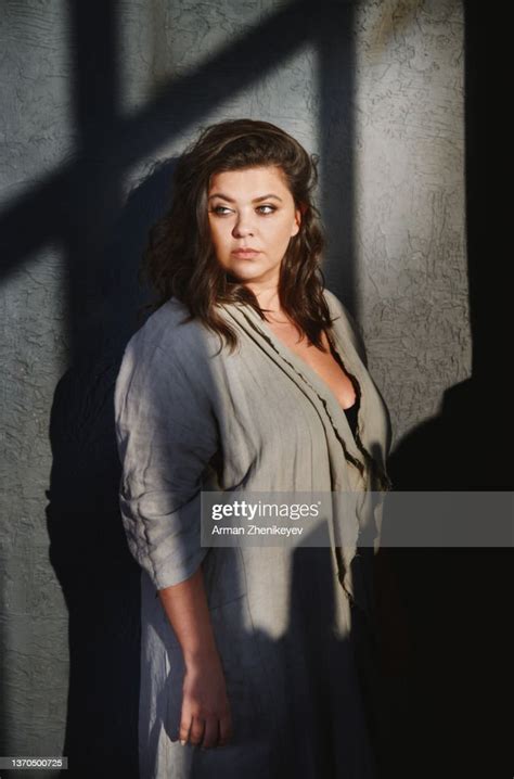 Beautiful Plus Size Model Against The Wall With Shadows High Res Stock