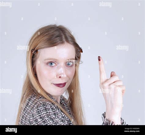 Young Woman Raising Index Finger Making A Point Stock Photo Alamy