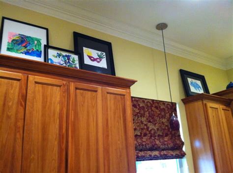 Displaying Kids Art Over Kitchen Cabinets Used Old Frames And Stuck