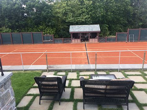 Close up view of tennis racket and balls on the clay tennis court. Timbers - Watch Hill, Rhode Island - HALI BECKMAN, Ltd.