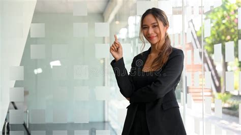 Confident Asian Young Businesswoman In Black Suit Standing In Office