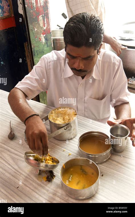 Man Eating Rice With Sambar And Vegetable Curry From His Tiffin Box Lunch Box In Pondicherry
