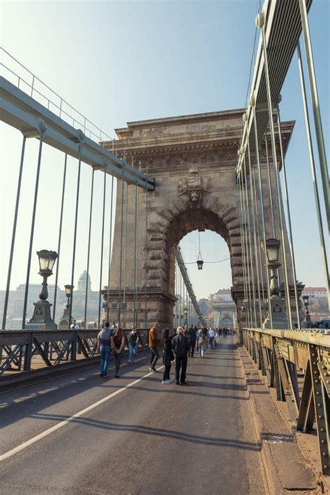 People Walking Across Famous Szechenyi Chain Bridge In Budapest
