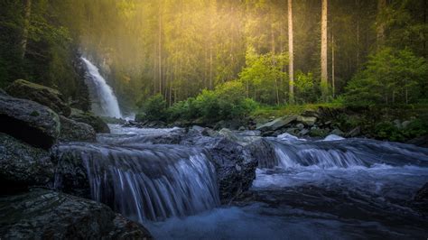 Sun Shining On Forest Waterfall