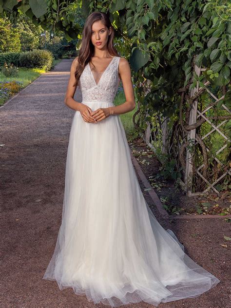 A Line Wedding Dress With A Deep V Neckline Lace Bodice And Illusion Back