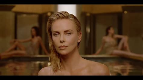 charlize theron walking naked out of a pool is what female empowerment looks like in dior s