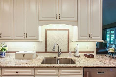 Painted kitchen cabinets white cabinets dark countertops and. Accent tile creates a great feature above the kitchen sink ...