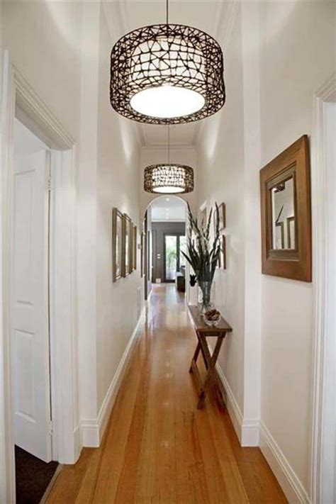 Narrow Hallway With Wall Mirrors And Hanging Lighting Decorating