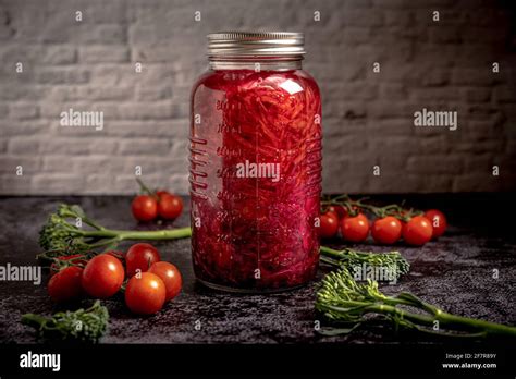 Dark Moody Food Photography Of A Jar With Homemade Fermented Red