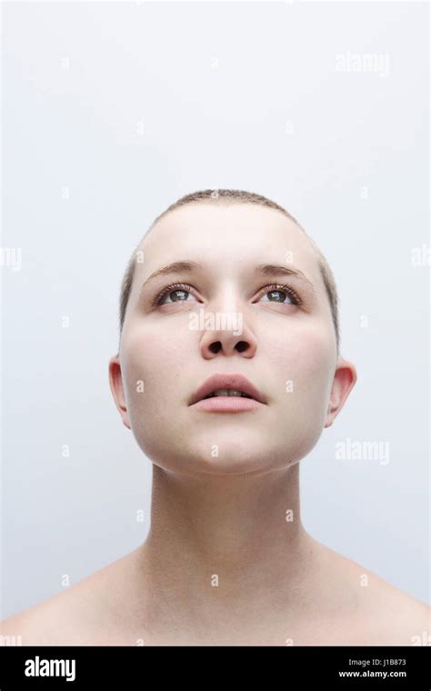 Caucasian Woman With Shaved Head Looking Up Stock Photo Alamy