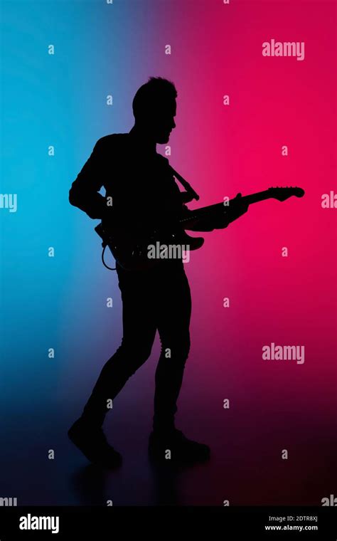 Party Silhouette Of Young Male Guitarist Isolated On Blue Pink