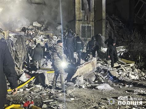 A Woman Clutching An Infant Is Found In The Rubble Of Ukraine Building After Russian Drone