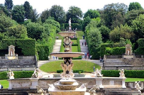 An Elaborate Fountain In The Middle Of A Formal Garden