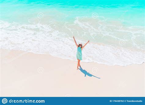 Happy Girl At Beach Having A Lot Of Fun In Shallow Water Stock Photo