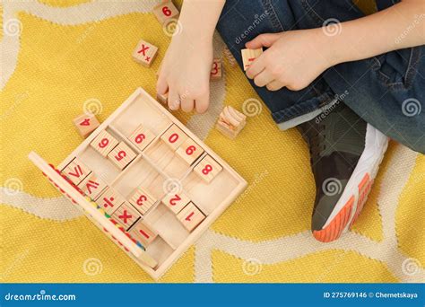 Child Playing With Math Game Kit On Floor Top View Learning
