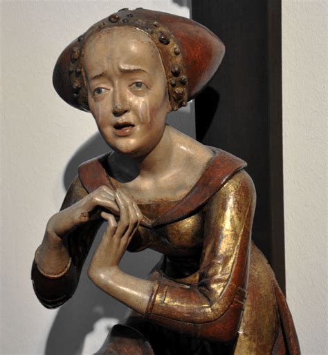 a statue of a woman with a hat on her head
