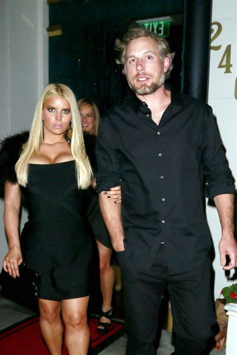 Jessica Simpson Wearing A Low Cut Black Dress While On A Night Out In