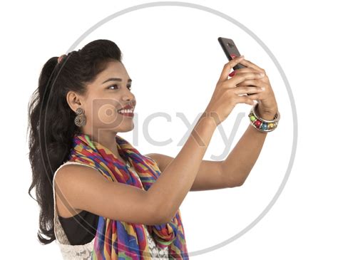 Image Of A Happy Young Indian Girl Taking Selfie With Smart Phone