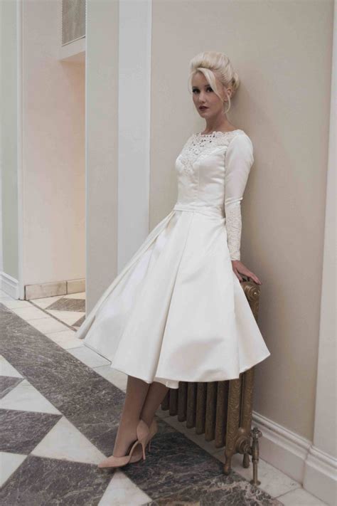 This strapless, lace wedding dress is the perfect gown for the bride aiming for a more causal look on her wedding day. Demure satin tea length wedding dress with long sleeves ...