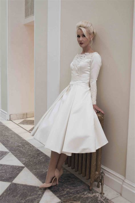 Looking for a satin wedding dress to create your perfect look? Demure satin tea length wedding dress with long sleeves ...