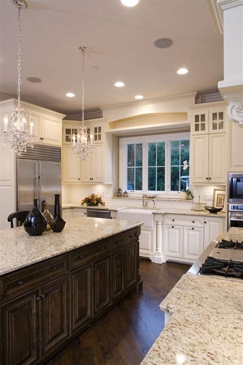 White and brown kitchen features white shaker cabinets paired with soapstone countertops and cream stone tile backsplash. 20 Magnificent Cream Color Kitchen Cabinets (WITH PICTURES)