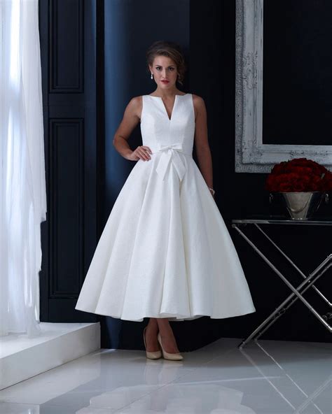 Brocade Tea Length Wedding Dress With Subtle Bow And Elegant Cut
