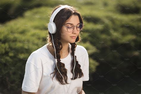 Woman With Headphones Outdoors In Featuring Headphones Music And Happy Technology Stock