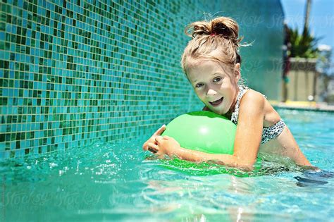 Girl In Pool With Green Ball By Gillian Vann Swimming Pool Stocksy United