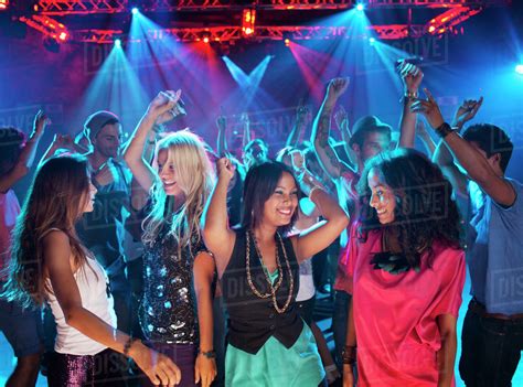Smiling Friends Dancing On Dance Floor Of Nightclub Stock Photo Dissolve