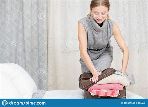 Beautiful Woman Packing Suitcase In Bedroom Getting Ready For Road Trip Stock Image Image Of