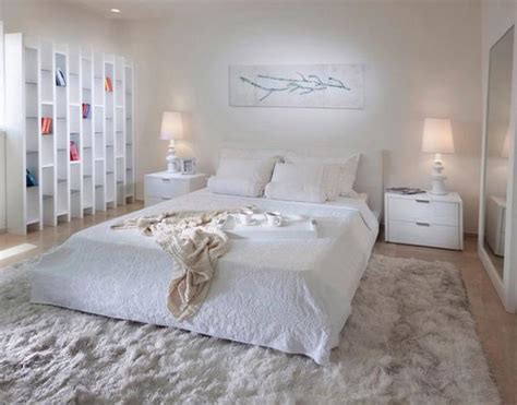 A few pops of orange and blue wake up the room. 4 Modern Ideas to Add Interest to White Bedroom Decorating