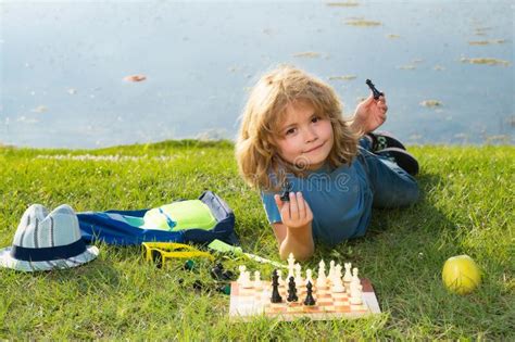 Kid Shows Chess Pieces On A Chessboard Early Development Boy Thinking