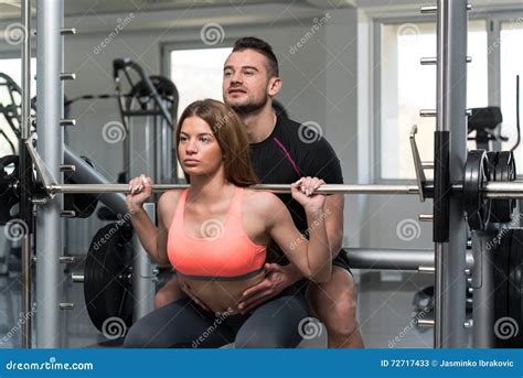 Gym Coach Helping Woman On Barbell Squat Stock Image Image Of Fitness Muscle 72717433