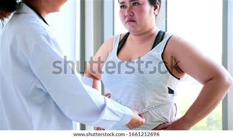 Female Doctor Measuring Worried Chubby Womans Stock Photo