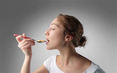 Premium Photo Woman Eating With A Spoon