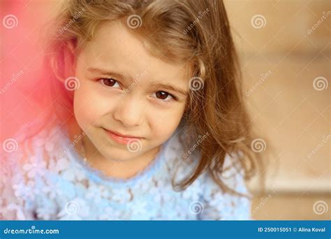 Cute Little Caucasian Girl With Blond Hair And A Serious Expressive