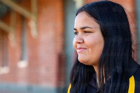 Image Of Head And Shoulders Of Teenage Girl Looking Across Frame