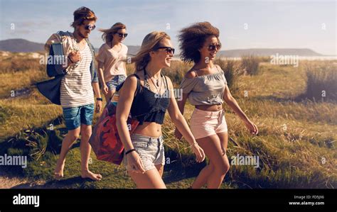 Portrait Of Group Of Friends Going To On The Beach Mixed Group Of